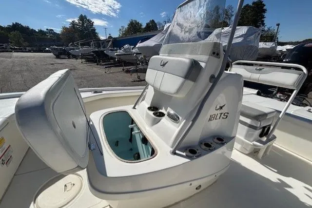 Slide: The Image of 2024 Mako 18 LTS boat interior with open storage compartment and seating. - 15