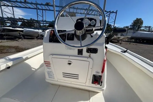 Slide: The Image of 2024 Mako 18 LTS boat console with steering wheel and controls. - 16
