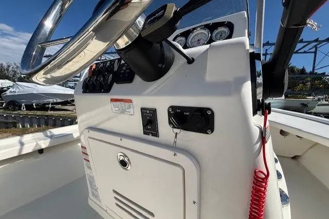 Slide: The Image of 2024 Mako 18 LTS boat console with steering wheel and gauges. - 17