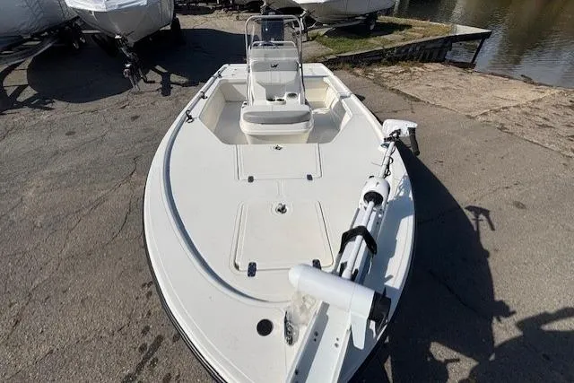 Slide: The Image of 2024 Mako 18 LTS boat, white deck, docked near water, featuring a trolling motor. - 21