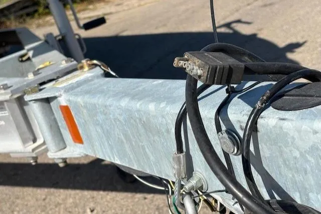 Slide: The Image of Trailer hitch and wiring of a 2024 Mako 18 LTS boat. - 23
