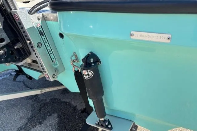 Slide: The Image of 2024 Mako 18 LTS boat transom with hydraulic components and identification plate. - 24