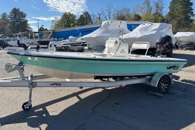 Slide: The Image of 2024 Mako 18 LTS boat on trailer, parked outdoors, under clear sky. - 3