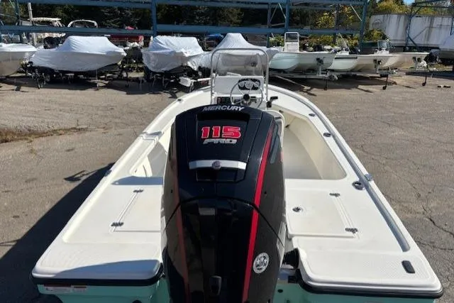 Slide: The Image of 2024 Mako 18 LTS boat with Mercury 115 Pro XS engine in a marina. - 8