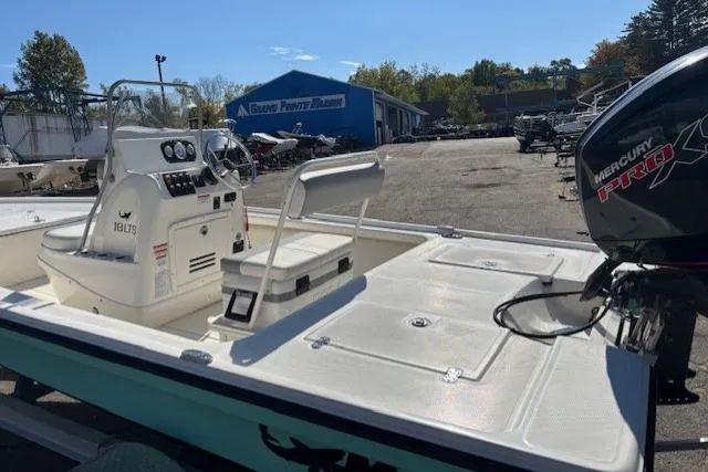 Slide: The Image of 2024 Mako 18 LTS boat with Mercury engine, parked outdoors in a marina. - 9