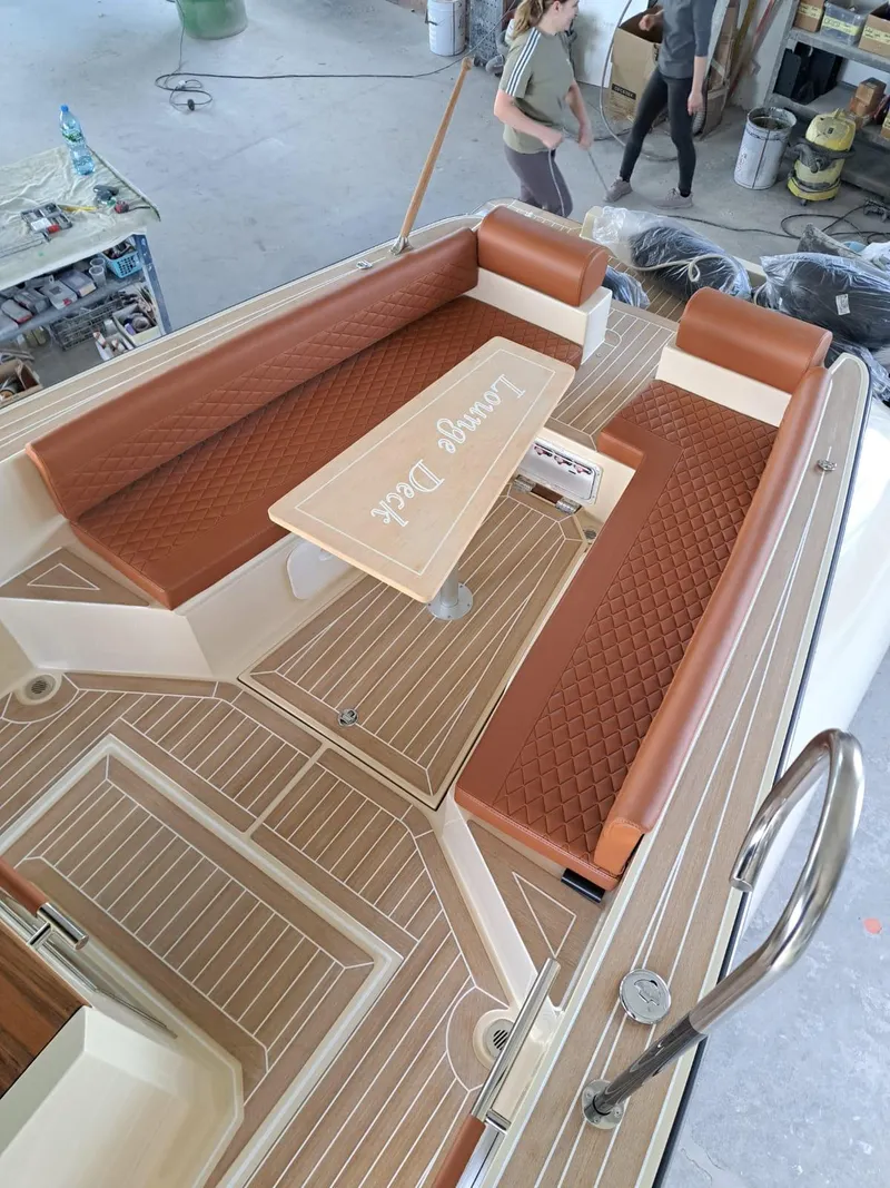 Slide: The Image of 2025 Lilybaeum Levanzo 25 Lounge Deck with brown seating and wooden flooring. - 22