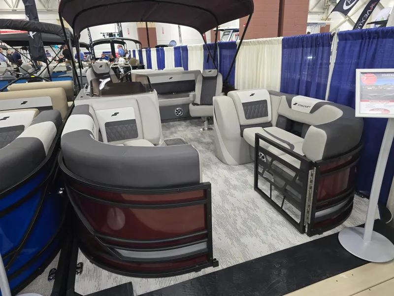 Slide: The Image of 2026 Starcraft SLS 3 DL pontoon boat displayed at a show. - 3