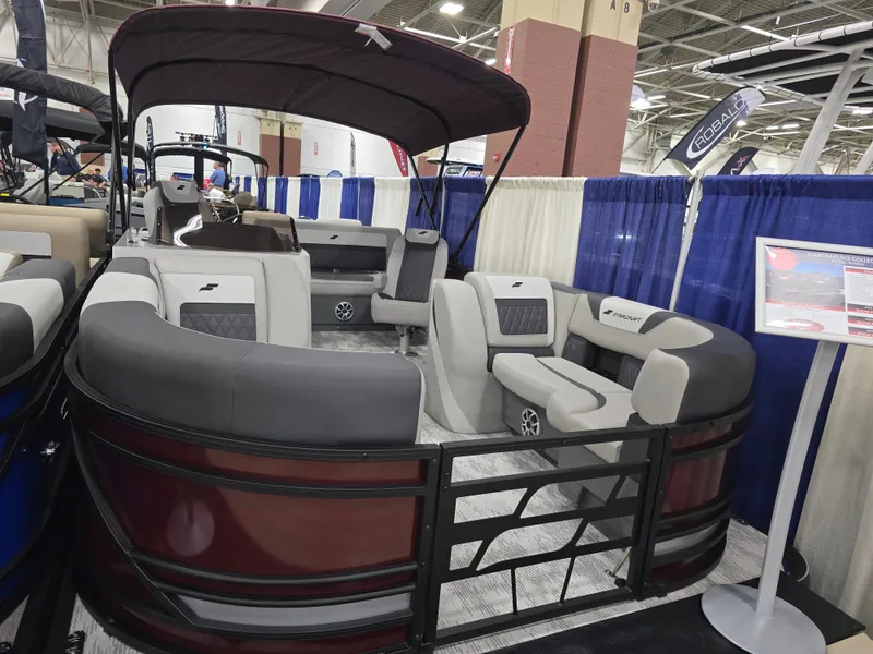 Slide: The Image of 2026 Starcraft SLS 3 DL pontoon boat displayed at a show. - 6
