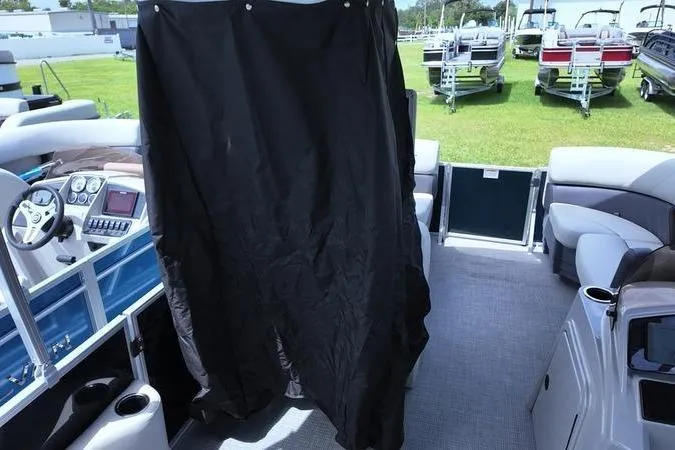 Slide: The Image of 2025 Sylvan Mirage 822 LZ pontoon boat interior with black privacy curtain. - 11