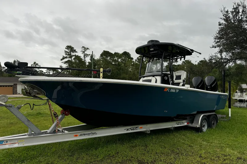 The Image of 2023 Tidewater 2700 Carolina Bay boat on trailer, parked on grass. - 0
