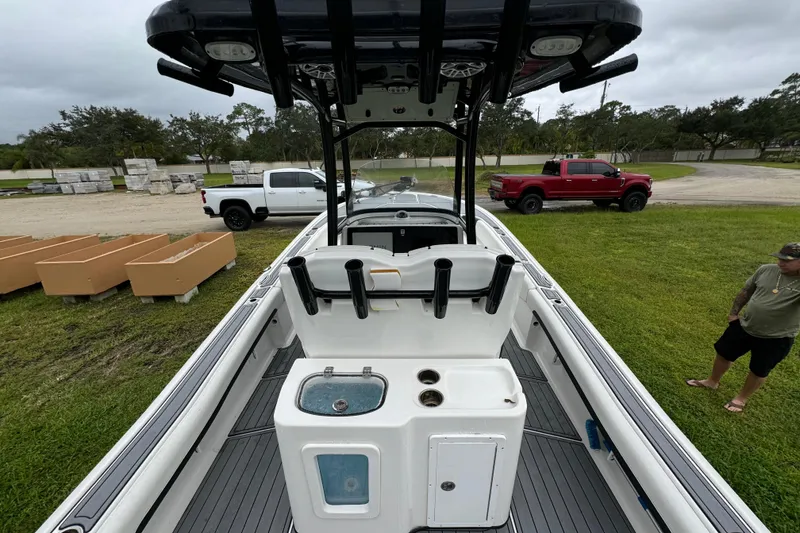 Slide: The Image of 2023 Tidewater 2700 Carolina Bay boat interior with fishing rod holders and livewell. - 12