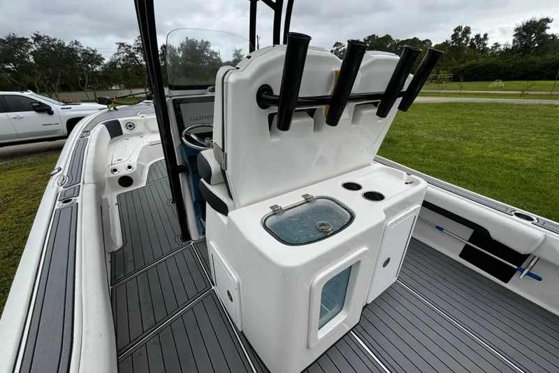 Slide: The Image of 2023 Tidewater 2700 Carolina Bay boat interior with rod holders and livewell. - 13