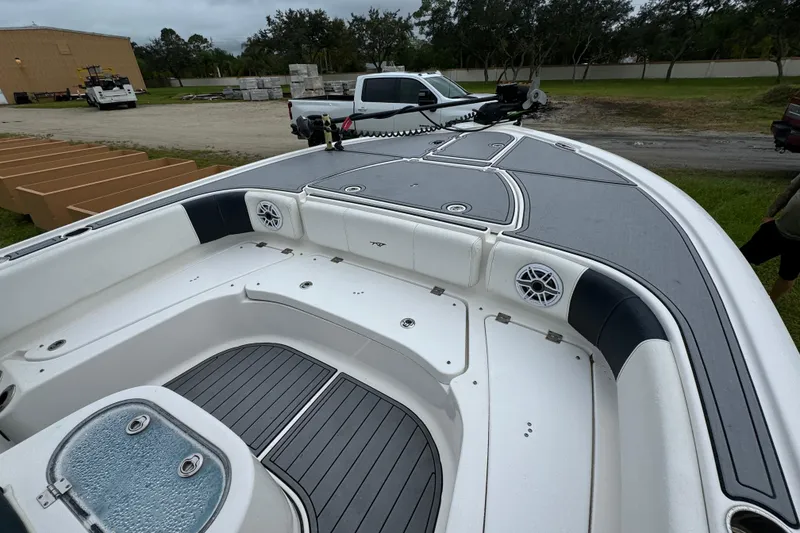 Slide: The Image of 2023 Tidewater 2700 Carolina Bay boat interior with seating and speakers. - 14