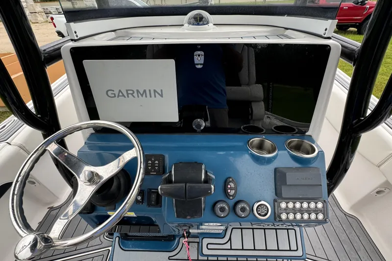 Slide: The Image of 2023 Tidewater 2700 Carolina Bay helm with Garmin display and steering wheel. - 16