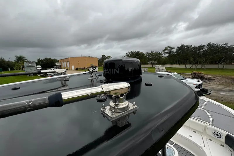 Slide: The Image of 2023 Tidewater 2700 Carolina Bay boat with radar and antenna, overcast sky background. - 18