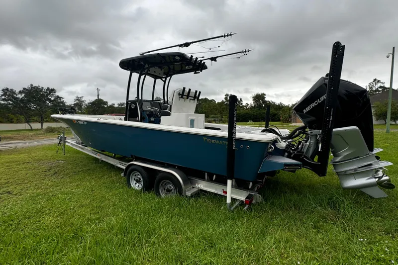 Slide: The Image of 2023 Tidewater 2700 Carolina Bay boat on trailer, parked on grass. - 2