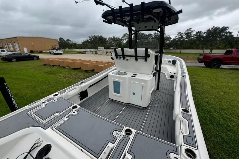 Slide: The Image of 2023 Tidewater 2700 Carolina Bay boat with sleek deck design, parked outdoors. - 5