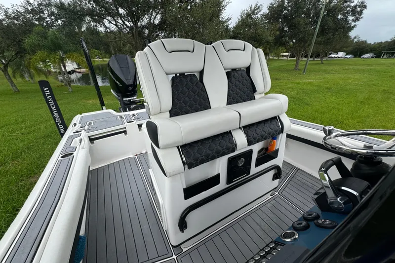 Slide: The Image of 2023 Tidewater 2700 Carolina Bay boat interior with dual seats and steering console. - 7
