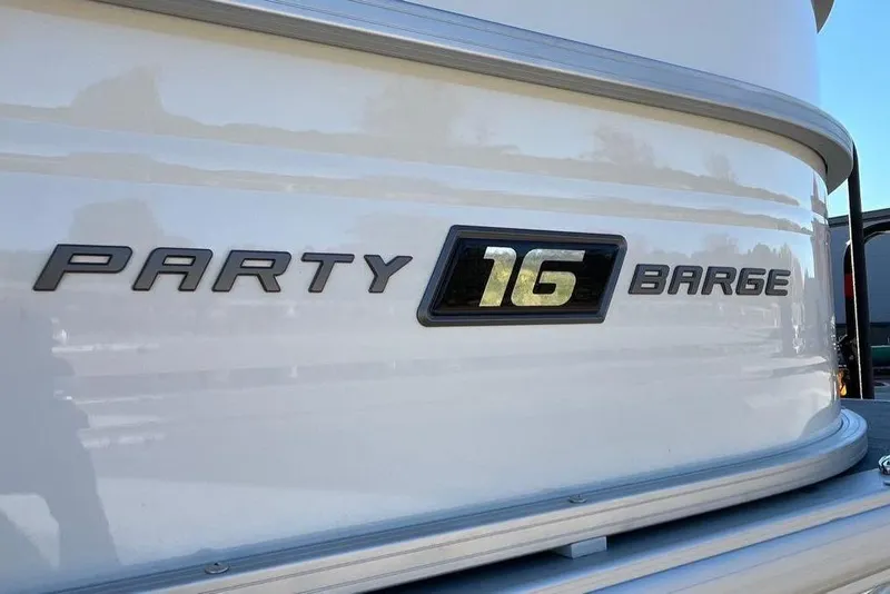 Slide: The Image of 2026 Sun Tracker Party Barge 16 DLX logo on boat exterior. - 2