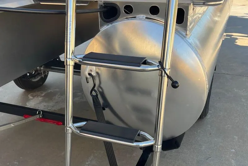Slide: The Image of 2026 Sun Tracker Party Barge 16 DLX pontoon ladder and trailer detail. - 5