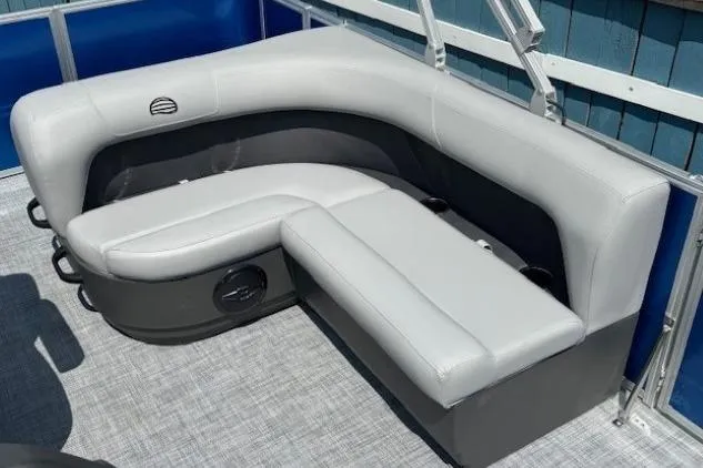 Slide: The Image of 2026 Sun Tracker Party Barge 18 DLX interior seating with gray upholstery and cup holders. - 18