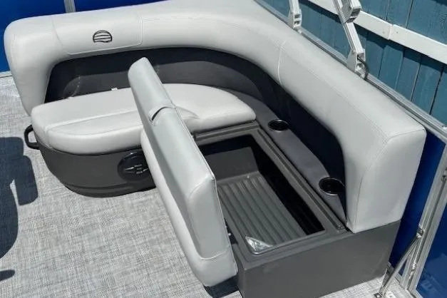 Slide: The Image of 2026 Sun Tracker Party Barge 18 DLX seating with storage compartment and cup holders. - 19