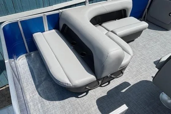 Slide: The Image of 2026 Sun Tracker Party Barge 18 DLX interior with gray seating and cup holders. - 20