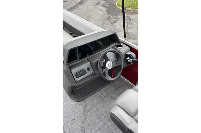 Slide: The Image of 2026 Sun Tracker Party Barge 18 DLX steering console with modern controls and seating. - 3
