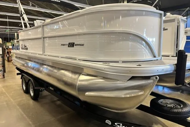 The Image of 2026 Sun Tracker Party Barge 20 DLX pontoon boat displayed indoors. - 0