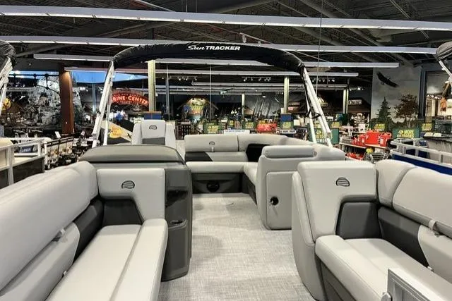 Slide: The Image of 2026 Sun Tracker Party Barge 20 DLX pontoon boat with spacious seating in showroom. - 3