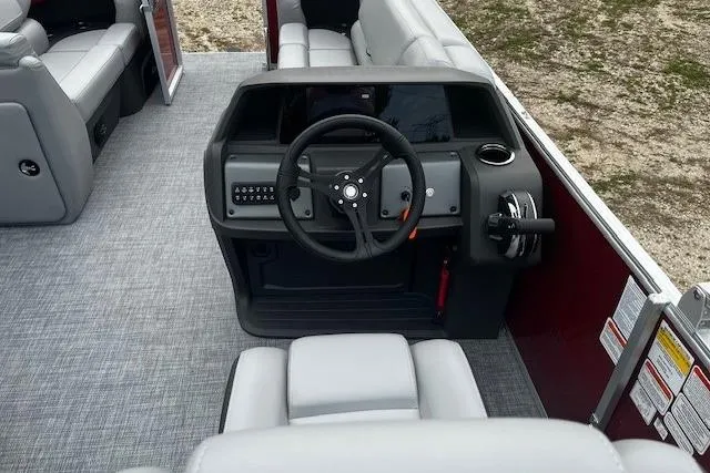 Slide: The Image of 2026 Sun Tracker Party Barge 20 DLX interior with steering console and seating. - 39