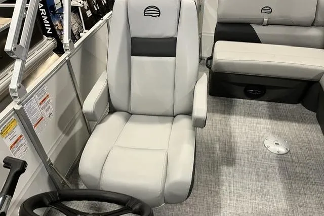 Slide: The Image of 2026 Sun Tracker Party Barge 20 DLX interior with gray captain's chair and seating. - 4