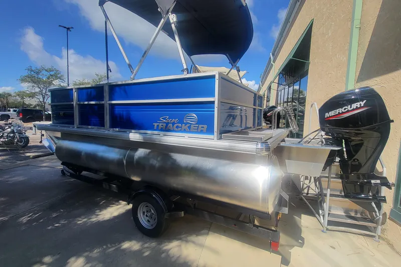 Slide: The Image of 2026 Sun Tracker Party Barge 16 DLX pontoon boat with Mercury outboard motor. - 2