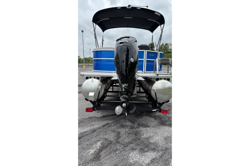 Slide: The Image of 2026 Sun Tracker Party Barge 20 DLX pontoon boat, rear view with motor and canopy. - 3