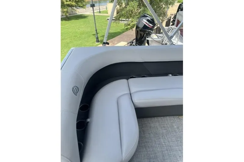 The Image of 2026 Sun Tracker Party Barge 16 DLX with gray seating and Mercury outboard motor. - 0