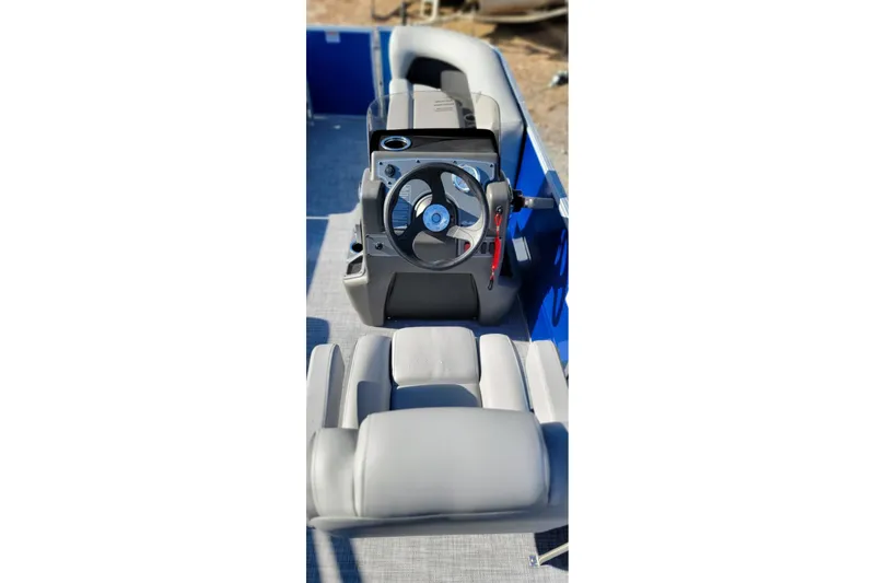 Slide: The Image of Interior view of 2026 Sun Tracker Party Barge 16 DLX with steering console and seating. - 3