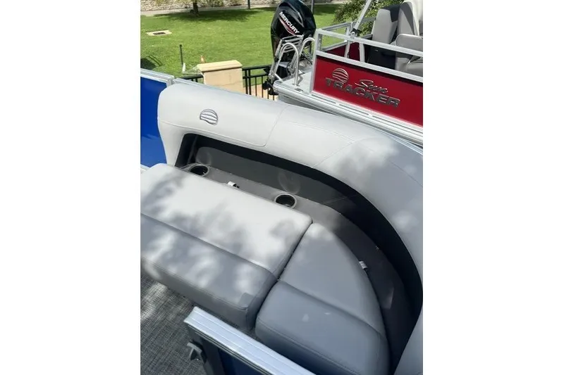 Slide: The Image of 2026 Sun Tracker Party Barge 16 DLX with comfortable seating and cup holders. - 5