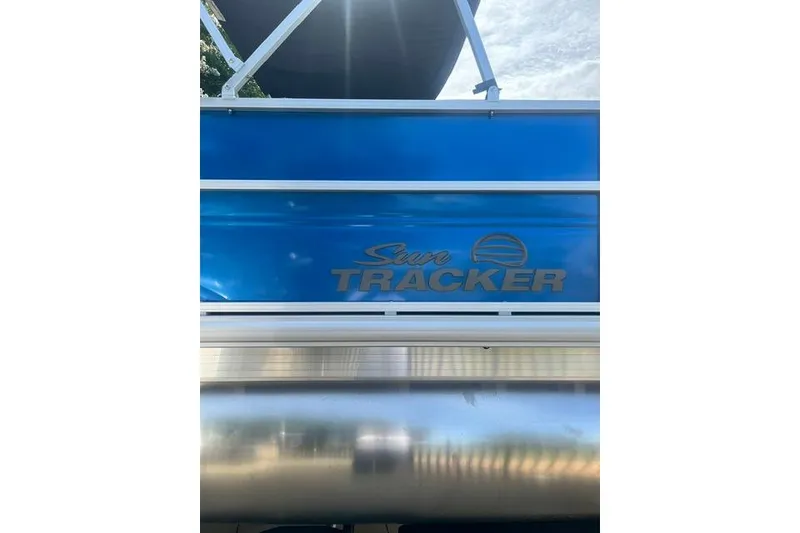 Slide: The Image of 2026 Sun Tracker Party Barge 16 DLX pontoon boat with blue exterior and logo. - 9