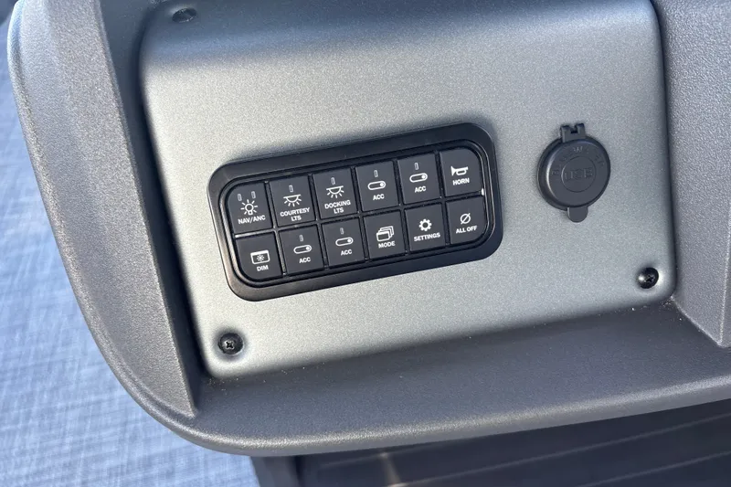 Slide: The Image of Control panel of 2026 Sun Tracker Party Barge 20 DLX with various switches and USB port. - 19