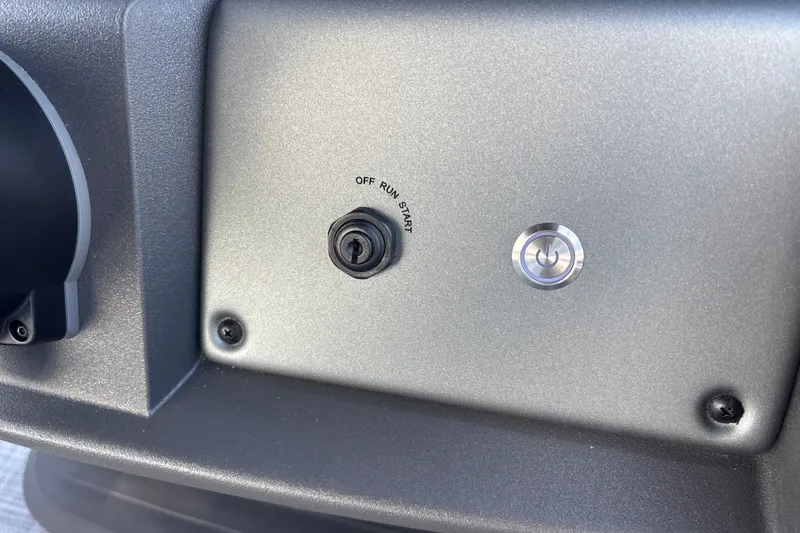 Slide: The Image of Dashboard ignition switch and power button on 2026 Sun Tracker Party Barge 20 DLX. - 20