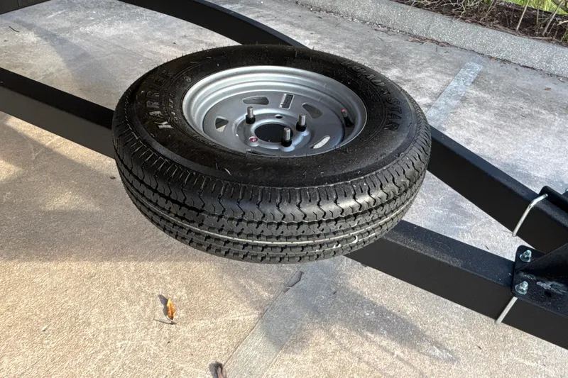 Slide: The Image of Spare tire mounted on a Sun Tracker Party Barge 20 DLX trailer, 2026 model. - 37