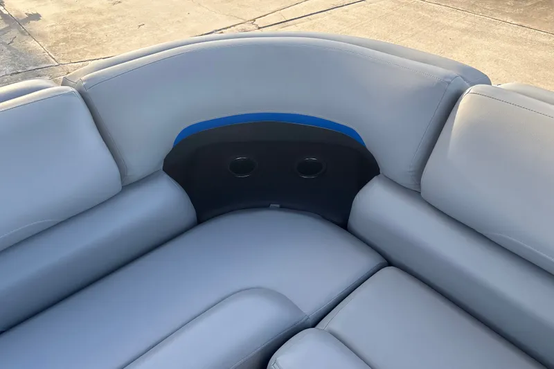 Slide: The Image of 2026 Sun Tracker Party Barge 20 DLX, featuring comfortable gray seating with cup holders. - 21