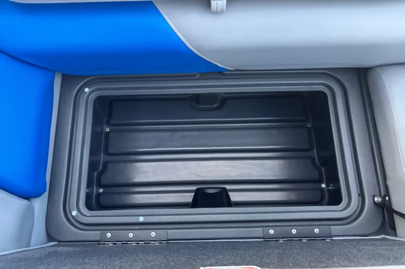 Slide: The Image of Storage compartment of 2026 Sun Tracker Party Barge 20 DLX with blue and gray seating. - 32
