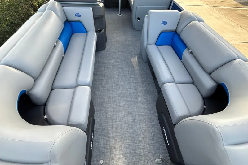 Slide: The Image of 2026 Sun Tracker Party Barge 20 DLX interior with gray and blue seating. - 13
