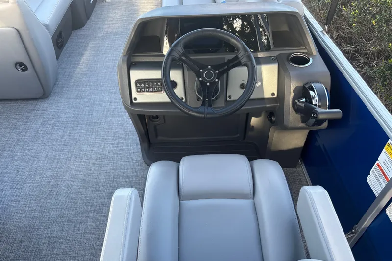 Slide: The Image of 2026 Sun Tracker Party Barge 20 DLX helm with steering wheel and controls. - 17