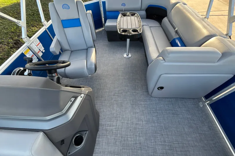 Slide: The Image of Interior of 2026 Sun Tracker Party Barge 20 DLX with gray seating and steering console. - 15