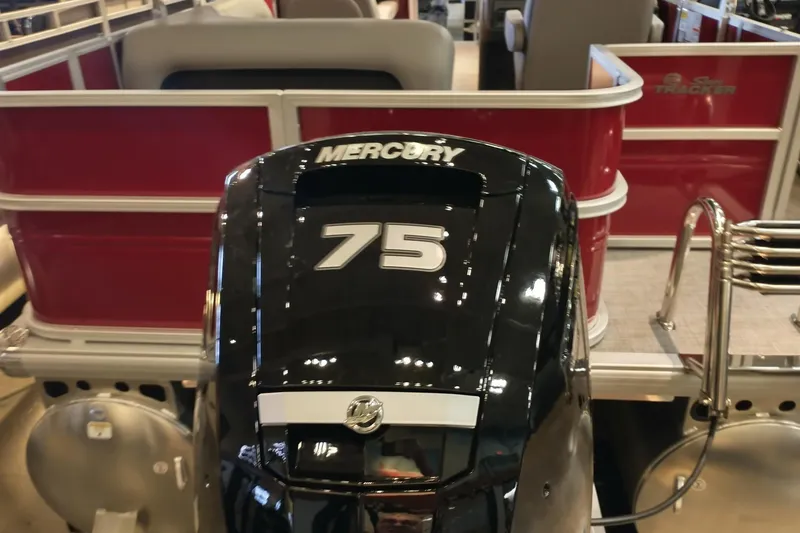 Slide: The Image of 2026 Sun Tracker Party Barge 18 DLX with Mercury outboard motor in showroom. - 4