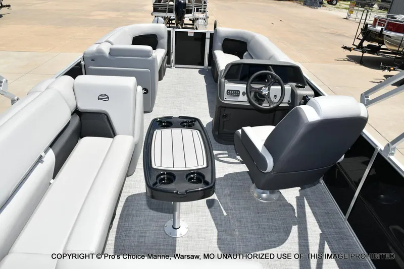 Slide: The Image of 2026 Sun Tracker Party Barge 20 DLX interior with seating and steering console. - 68