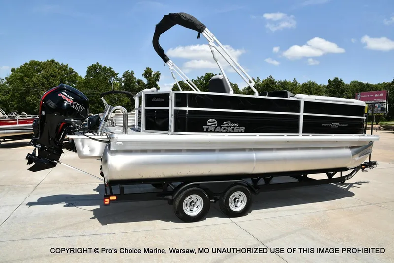 Slide: The Image of 2026 Sun Tracker Party Barge 20 DLX pontoon boat on trailer, outdoor display. - 72