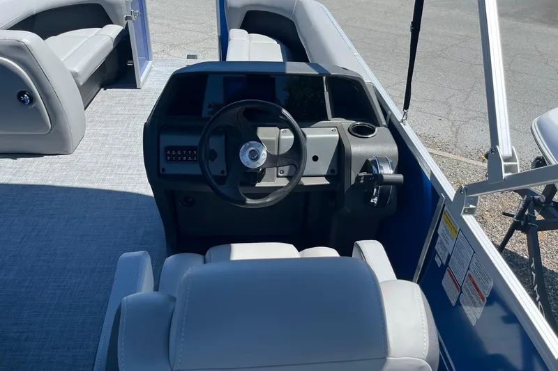 Slide: The Image of 2026 Sun Tracker Party Barge 18 DLX interior with steering wheel and seating. - 5